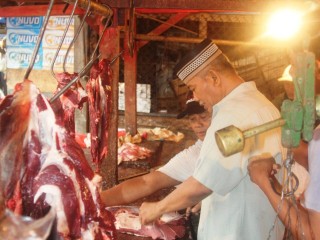 A wet market vendor selling beef and buffalo meat near Jakarta.