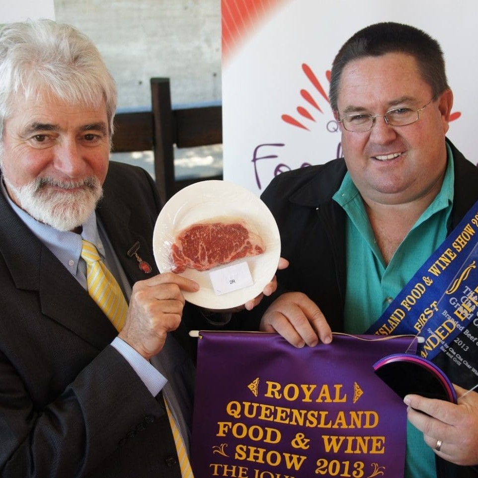 Wingham Beef Exports' Grant Coleman pictured with head judge, Russell Smith, with a sample of Manning Valley Naturally product judged grand champion at the 2013 RNA banded beef competition.