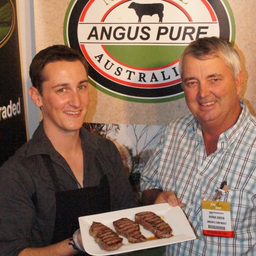 Country Fresh Nationwide's Michael White shows Expo visitor Warren Jonsson a sample of Angus Pure's convenient portion size
