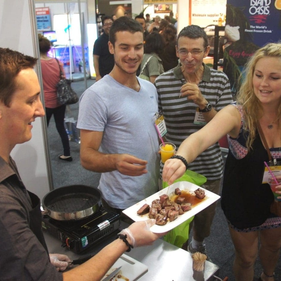 Fine Foods expo patrons enjoy a sample of Angus pure offered by Country Fresh Nationwide's Michael White