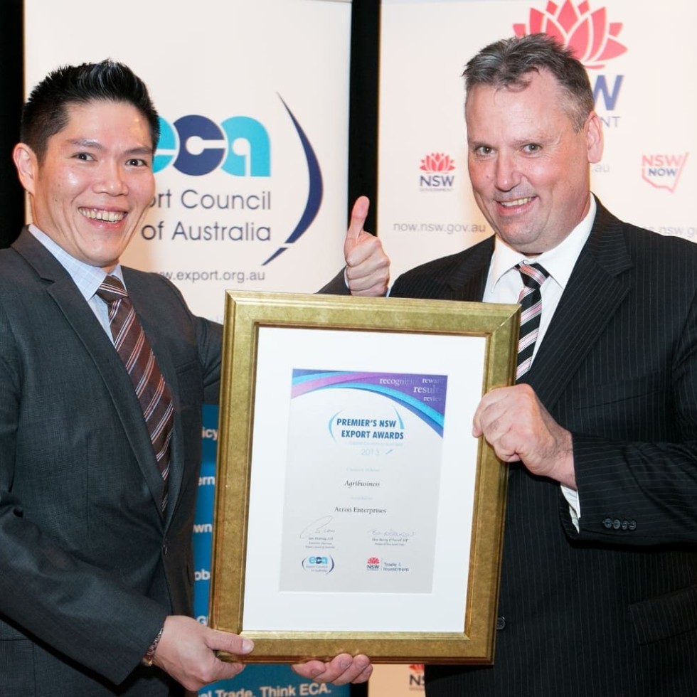 Atron's David Larkin accepts the NSW Export award at last night's presentation from Jodie Seah, Coface