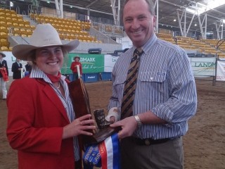 Federal Agriculture Minister Barnaby Joyce presents Calrossy Anglican School, Tamworth, year 11 student Amelia Riley, Wyalla, Duri, with the overall winner for junior judging the 2013 Landmark Beef Championships at Tamworth.