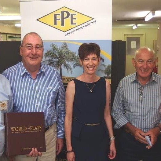 AMIC processor director Steve Martyn, left, presents copy number one of World on a Plate to TFI's Brian James, second from right, pictured with the Cancer Council's Kate Tonkin and FPE's Brian Carey and Jodie Teurlings.