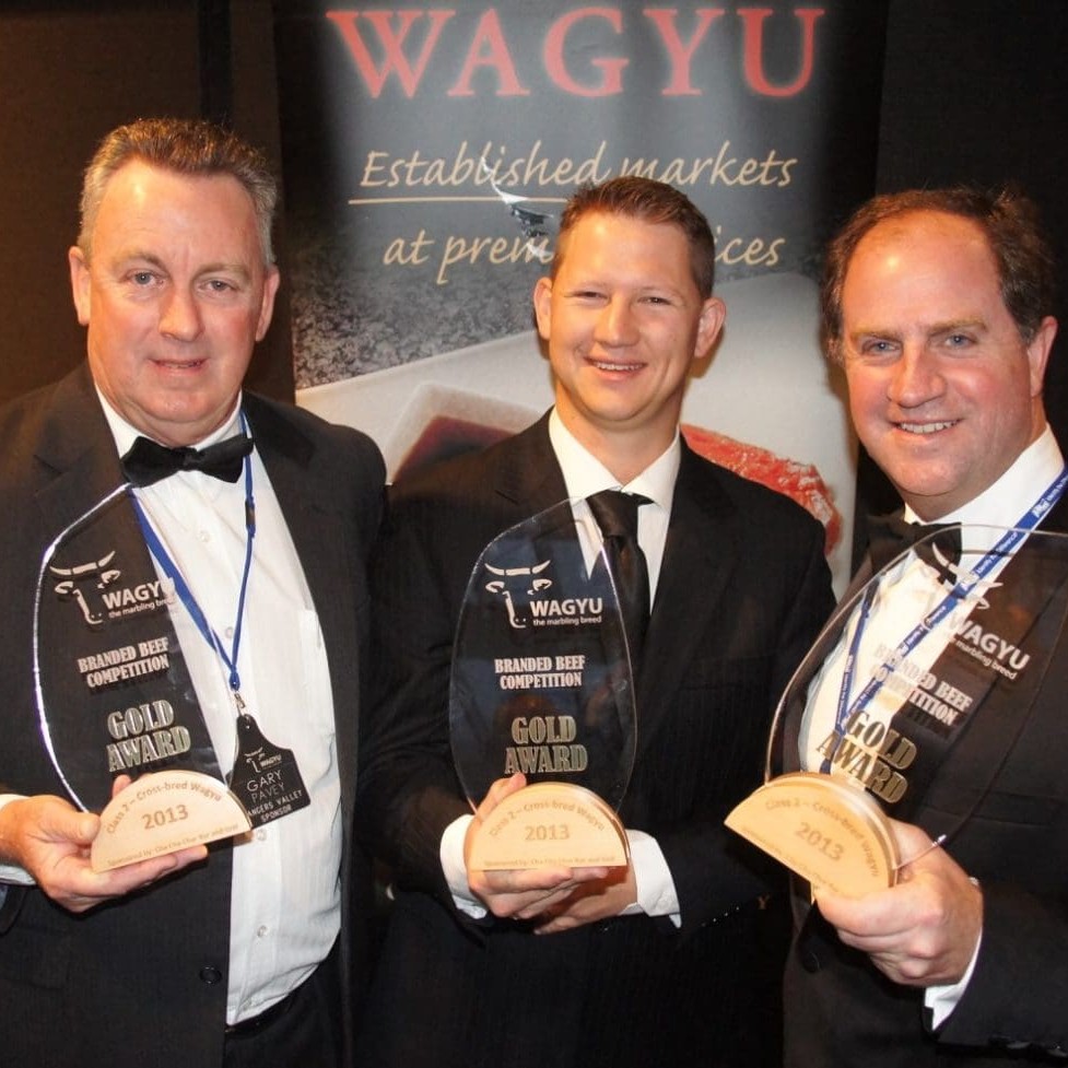 Rangers Valley's Gary Pavey, Stockyard's Lachie Hart and AA Co's Jacob English collect their gold medalist trophies for the crossbred Wagyu beef division