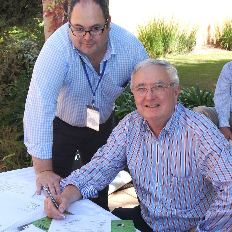 CCA chief executive Jed Matz and Teys general manager livestock Geoff Teys sign licence documents signifying the launch of the Pasturefed Cattle Assurance System yesterday.