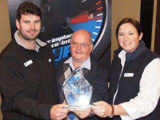 Bill James receives his Outstanding Service to Industry award from Elanco's Nathan Surawski and Liz Pearson