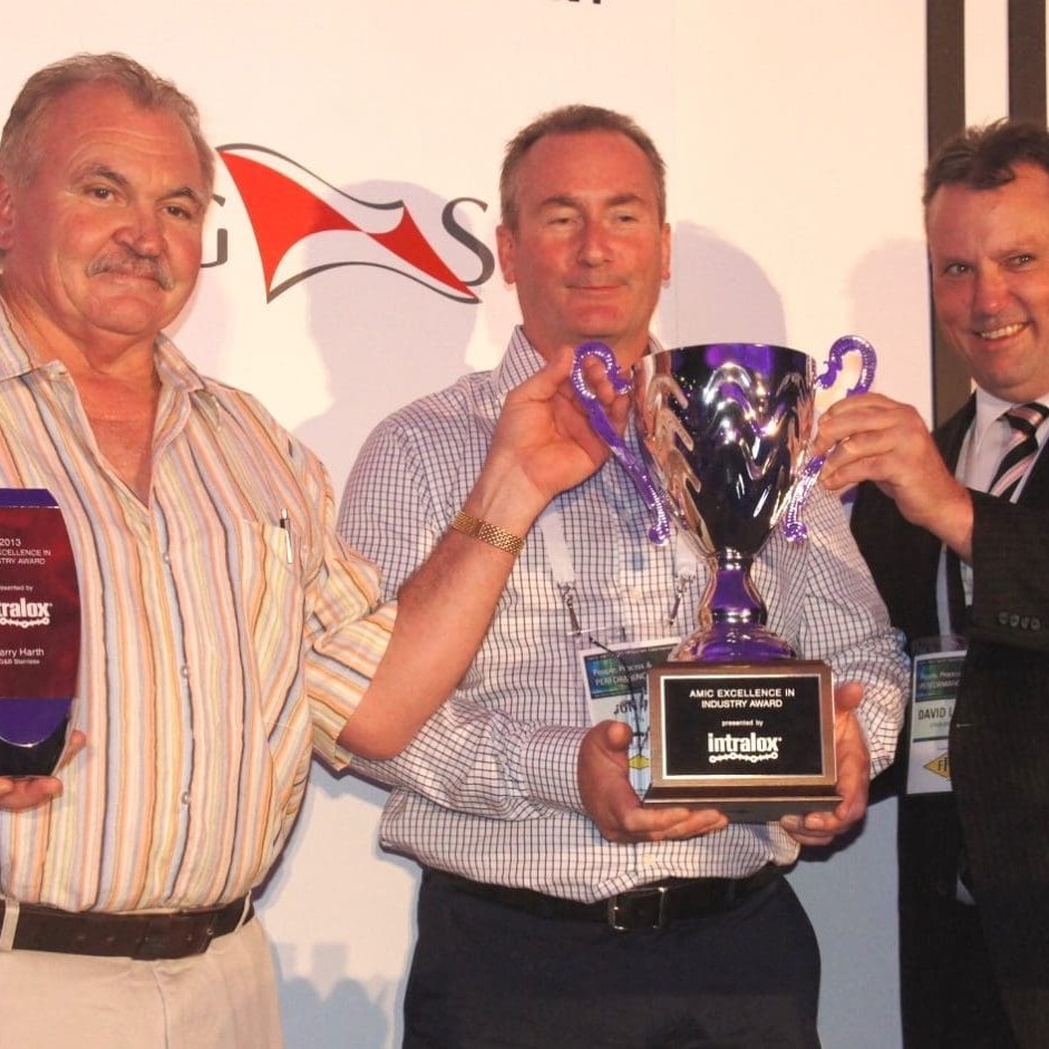 Barry Harth from G&B Stainless, left, accepts his excellence in industry award from Intralox's Jon Ball and AMIC's David Larkin