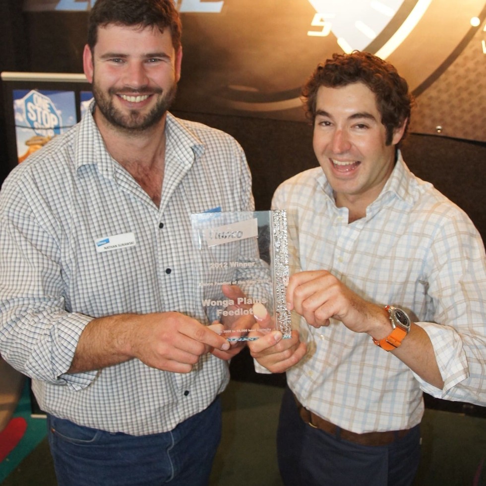 Elanco's Nathan Surawski presents the 2012 Feedlot of the Year award to Bryce Camm, Wonga Plains