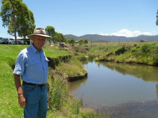 Carey Bros Meats' second-generation owner Greg Carey inspects the flood-eroded river banks beside his abattoir which will be revegetated with help from natural resource management group Condamine Alliance.