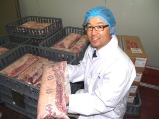 Hokubee staffmember Kazu Tokumoto with a striploin which has undergone the Meltique process in the company's Wauchope plant