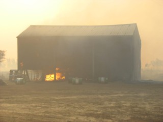 Flames claim a shed during last year's bushfires in central Queensland. 