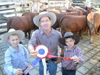 Central Queensland cattle producer Ken McKenzie with his sons Darcy,14 years (left) and Thomas, 11 years, from Yaralla, Blackwater, pose with their grand champion pen of 10 grainfed steers, all milk tooth Droughtmasters averaging 631kg liveweight.   