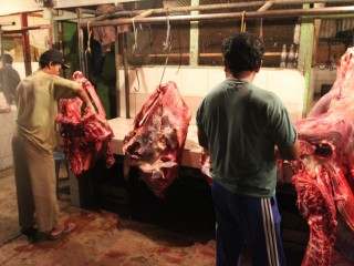 Butchers break down carcases for sale to Bakso ball manufacturers in a Jakarta wet market.