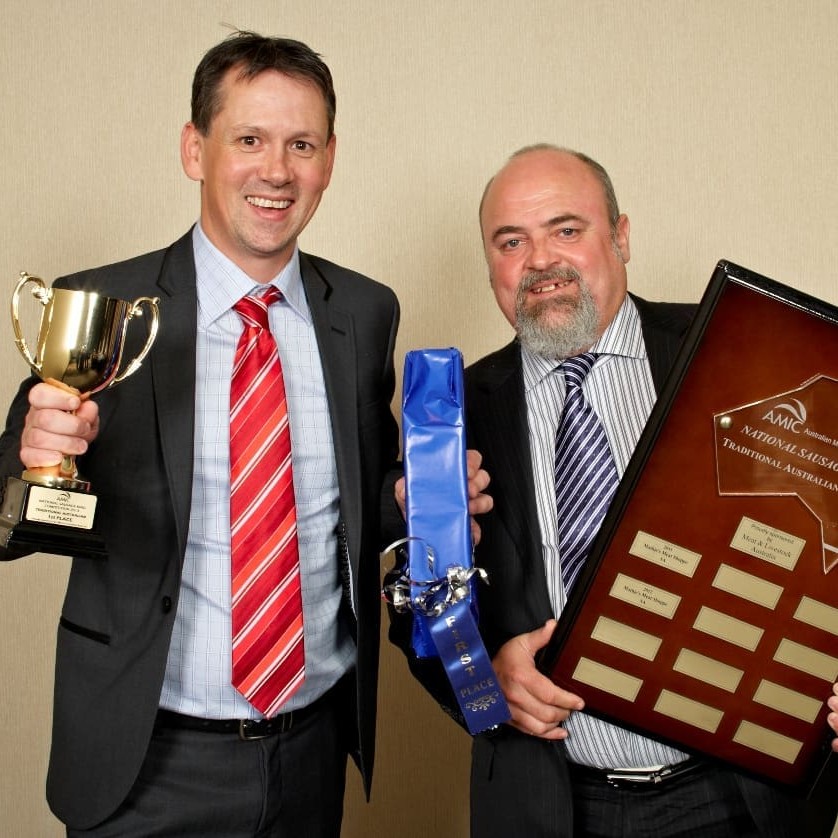 Clare, SA butcher Jason Mathie is congratulated for his National Sausage Kings award by MLA domestic market manager Lachlan Bowtell   