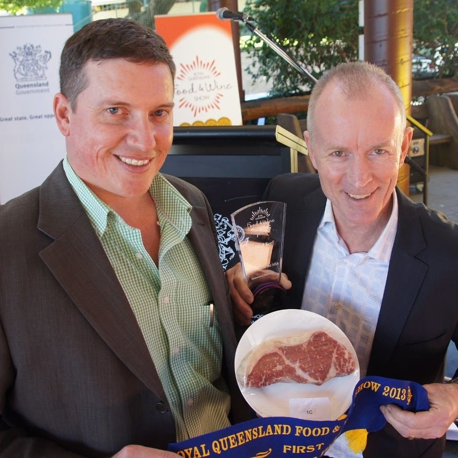 JBS's Brendan Tatt receives congratulations for the company's win in the MSA grainfed class from one of the Brisbane branded beef competition judges, respected Brisbane chef David Pugh