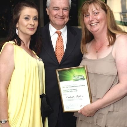 Rebecca Norris from Mission Australia in Goulburn and dinner host, Mike Munroe congratulate Claire Graham from Southern Meats on the employment award