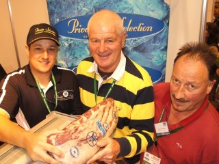 Beef & Lamb New Zealand chief executive officer Rod Slater, centre, and kiwi butcher Don Andrews, right admire a sample of Nolans Private Selection held by sales representative, Tom Briggs during a recent retail butchery industry exhibition.
