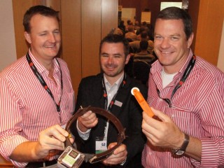 Dr Mark Trotter, centre, with AA Co's Troy Setter and Paraway Pastoral's David Goodfellow, holding a GPS-linked collar used for research purposes and a Taggle tag which uses triangulation to locate stock. research  