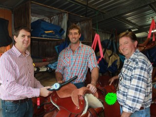 Toowoomba saddlemakers Clint (centre) and Paul (right) Gollan and Ross York from Datamars read a saddle-embedded RFID chip.