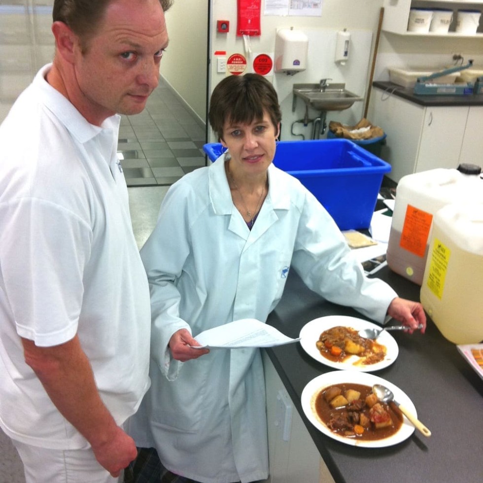 General manager Brett McMullen checks a VA product under development with a staffmember in Earlee's test kitchen