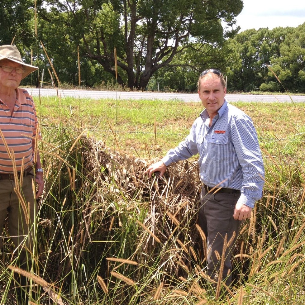 Ian Campbell, left, with regional sales manager Andy Divall clearing debris from Mr Campbell's fences near Lismore following the most recent floods.