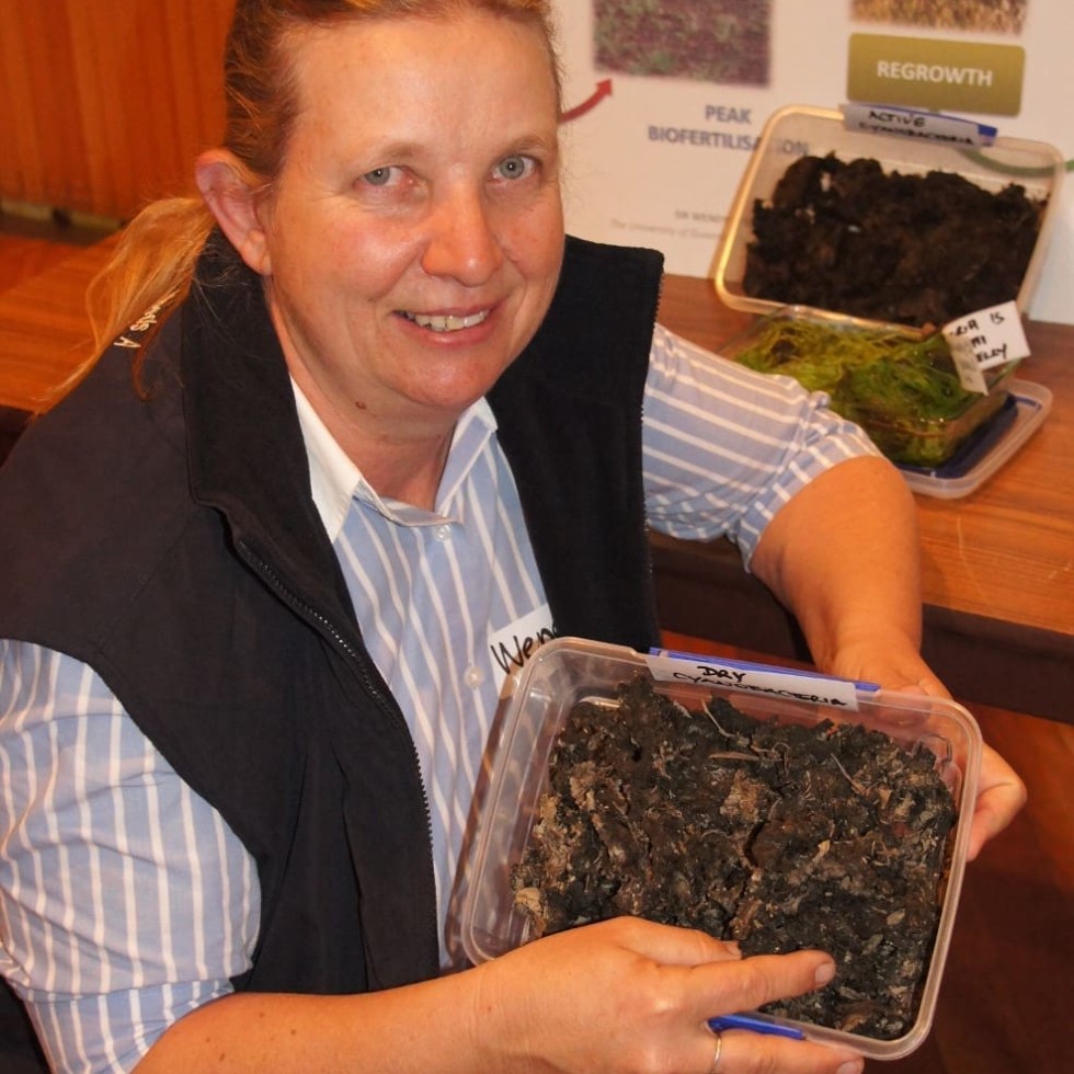 UQ's Dr Wendy Willliams with a sample of cyanobacteria 'crusts'  that might hold a key to boosting soil nitrogen and carbon levels  