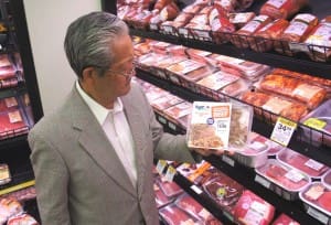 Retired Japanese meat trader Bully Kohno holds a sample of Sunpork's pre-cooked pulled brisket in the Woolowrths Gasworks store.