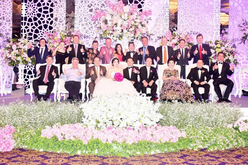 Pictured at the recent wedding of Catherine Hasan, the daughter of Sanko Hasan (PT TUM), to Ronald Irawan in Jakarta, are (standing from left): Hamish Shannon, Elders; Anna Gooden, Tony Gooden, Frontier; Dick Slaney, Elders; John and Ayu Ackerman, Daryl Hasan PT TUM; Ashley James and Will McEwin, Frontier, Jake Morse, Austrex; Cameron Hall, Elders; (seated from left) James Nason, Beef Central; Ross Ainsworth; Buntoro Hasan PT TUM, Catherine and Ronald Irawan, Pudjantoro (PJ) Hasan PT TUM, Sanko Hasan PT TUM and Patrick Underwood, Elders.