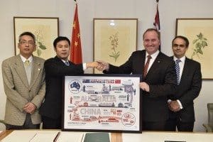 Mr CAI Wei, Deputy Head of Mission / Minister, Embassy of the People’s Republic of China in Australia; Dr LI Jianwei, Director General, AQSIQ; Minister Joyce; Mr Tim Chapman, First Assistant Secretary, Department of Agriculture Minister Joyce presenting a gift to Dr LI Jianwei - a framed diagram showing the beef cattle supply chain between Australia and China.