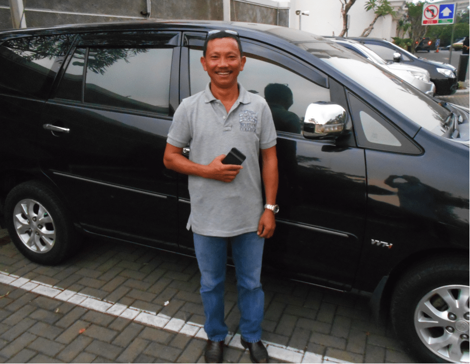 Nyoman with his ever-present grin, the latest model Toyota, smart phone and RM Williams boots.