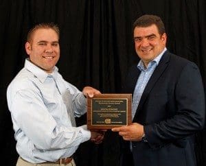 AA Co's Jason Strong receives his AMSA award from Jason receiving his award from America’s Food Safety Net Services Alex Brandt.