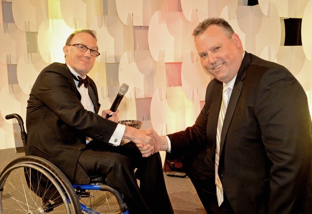 AMIC chairman David Larkin congratulates Special Industry Award recipient, Dr Peter Barnard