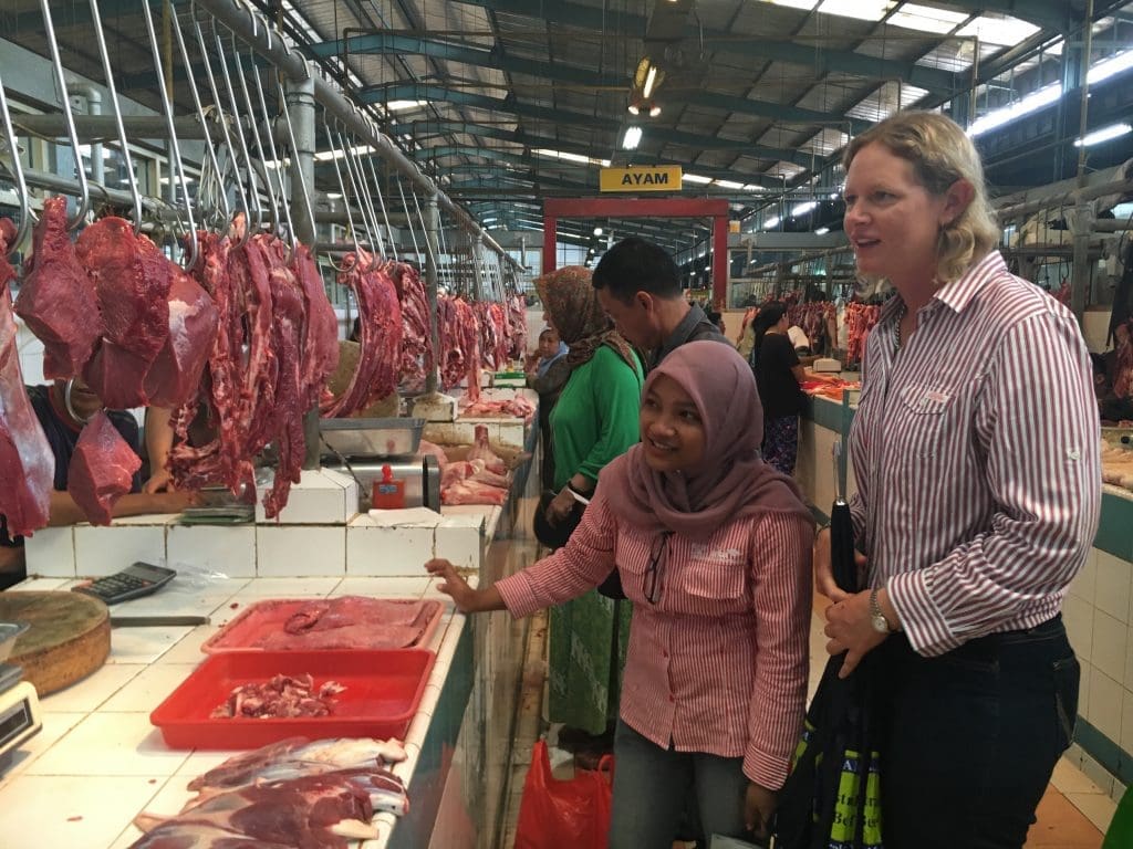 Tania Hartwig and associate judge Febrina Prameswari looking through a wet market.