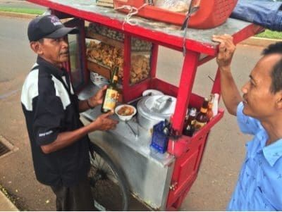 Jakarta taxi driver getting his $2 bakso soup at a roadside stall. Picture: Dr Ross Ainsworth.