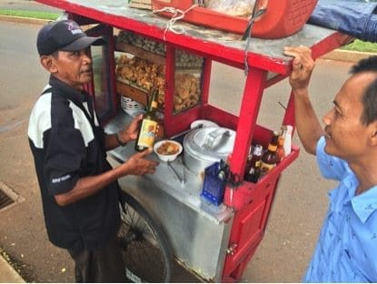 Jakarta taxi driver getting his $2 bakso soup at a roadside stall.