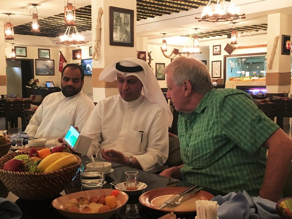 ALEC chairman Simon Crean is shown the new home delivery app by KLTT chief executive officer Osama Khalid Boodai during an industry supply chain visit to Kuwait last week.