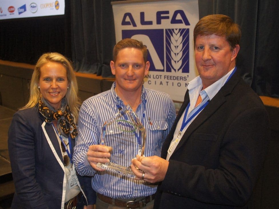 2015 Young Lotfeeder Andrew Slack is congratulated by Phibro's Thomas Wakeford and Smithfield feedlot's Barb Madden. 