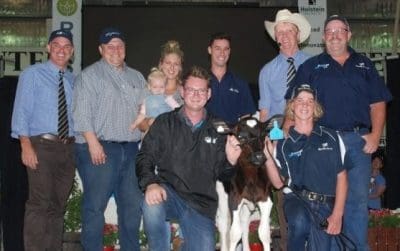 Owner Declan Patten with his Holstein heifer calf Gigi and buyer connections after last month's $251,000 record sale.