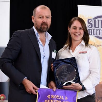 Sponsor Chris Higgins from Boutique Venues presents the grand champion trophies in Brisbane's branded beef competition to Sophie Kennedy from Stockyard.