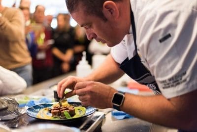 MLA executive chef Sam Burke plating-up