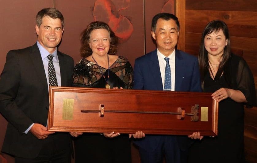 Gina Rinehart and a staffmember present Shanghai CRED's chairman, Mr Gui, with an original 'SK' Kidman branding iron, during last week's inaugural Kidman board meeting in Shanghai